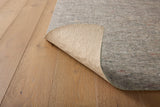 Loloi Loloi- Grip 1/4" Rug Pad in Grey, corner turned over, showing the underside