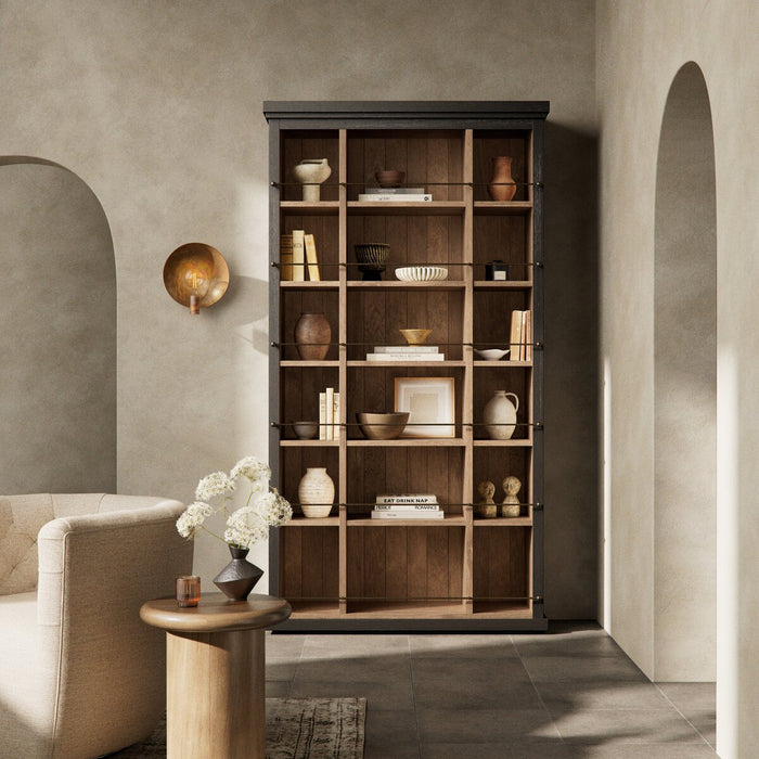 Wooden bookshelf in a room with a beige sofa and decorative items.