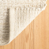 Dash & Albert Dunes Handwoven Jute Rug in Bleached Oak, corner turned back
