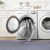 Dash & Albert Herringbone Machine Washable Rug in Navy, laundry room setting