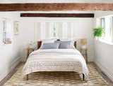 Dash & Albert Mosaic Handwoven Jute Rug in Blue, bedroom setting