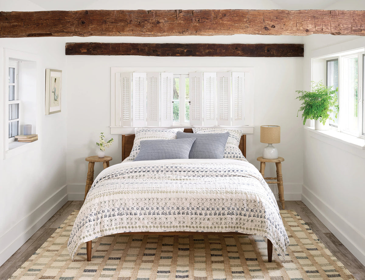 Dash & Albert Mosaic Handwoven Jute Rug in Blue, bedroom setting