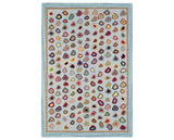 Rug with a Cat's Paw Hand Micro Hooked pattern on a plain background