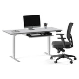 BDi Centro Sit+Stand Desk in Satin White on Oak with Grey Glass, 24 x 60 inch top, keyboard drawer open, with a chair, on white, 24" x 60" Top size