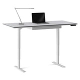 BDi Centro Sit+Stand Desk in Satin White on Oak with Grey Glass, 30 x 66 inch top, raised, with a lamp and laptop, on white, 30" x 66" Top size