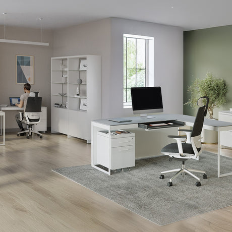 BDi Centro 6407 Mobile File Pedestal in Satin White on Oak, under a desk, in an open office