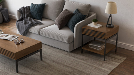 BDi Cora 1176 End Table in Natural Walnut, beside a sofa with the matching coffee table