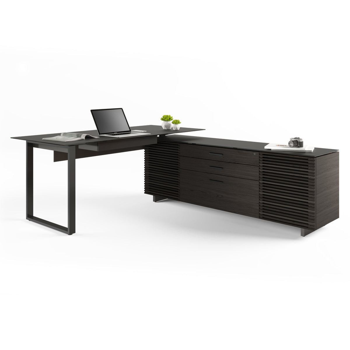 BDi Corridor 6531 L-Shaped Office Desk in Charcoal Stained Ash, angled view with a laptop, on white