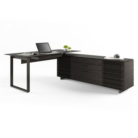 BDi Corridor 6531 L-Shaped Office Desk in Charcoal Stained Ash, angled view with a laptop, on white