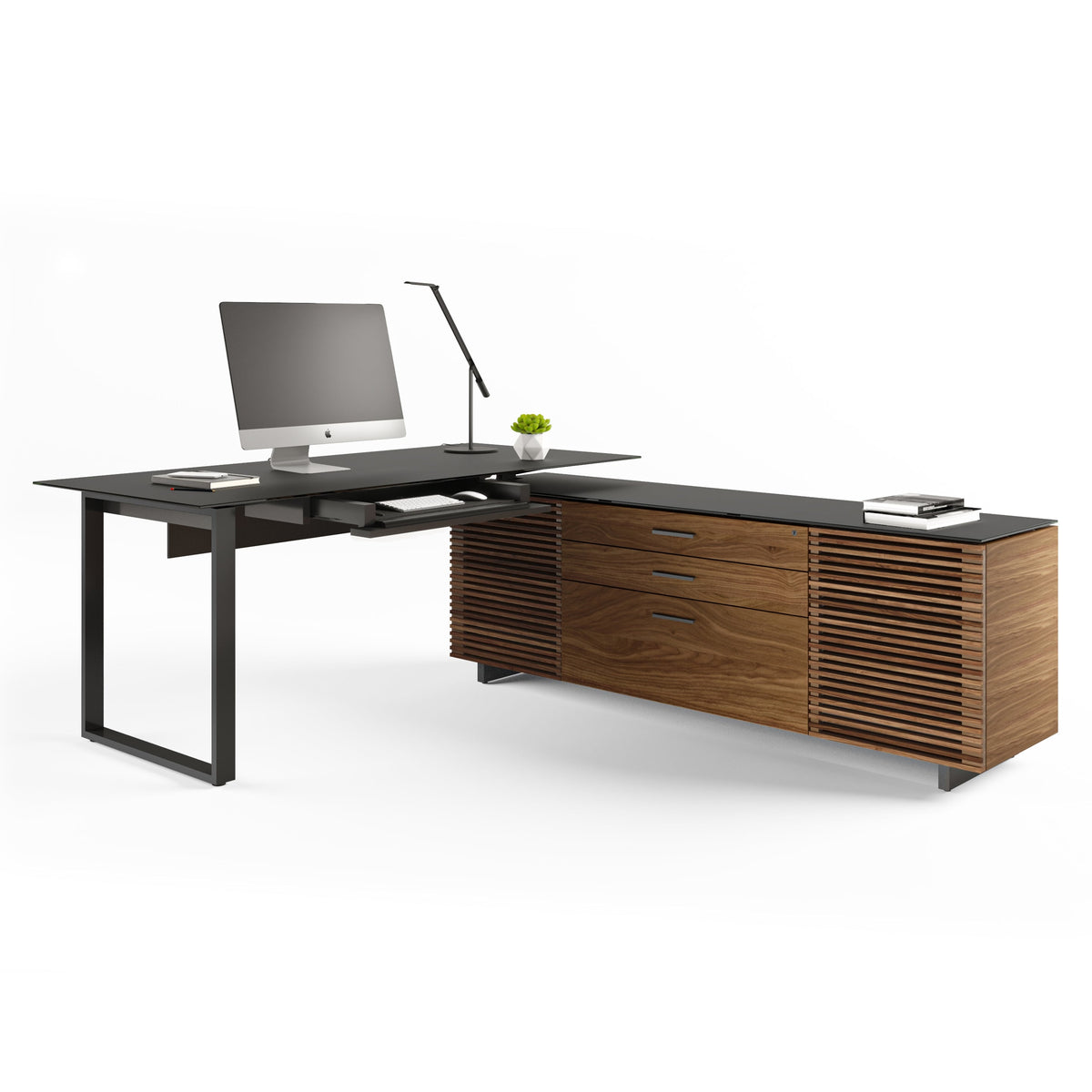 BDi Corridor 6531 L-Shaped Office Desk in Natural Walnut, angled view with a computer and the keyboard tray out, on white