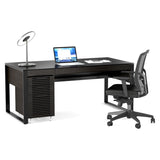 BDi Corridor 6521 Executive Office Desk in Charcoal Stained Ash, angled view with a file pedestal and chair, on white