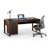 BDi Corridor 6521 Executive Office Desk in Chocolate Stained Walnut, angled view with a file pedestal and chair, on white