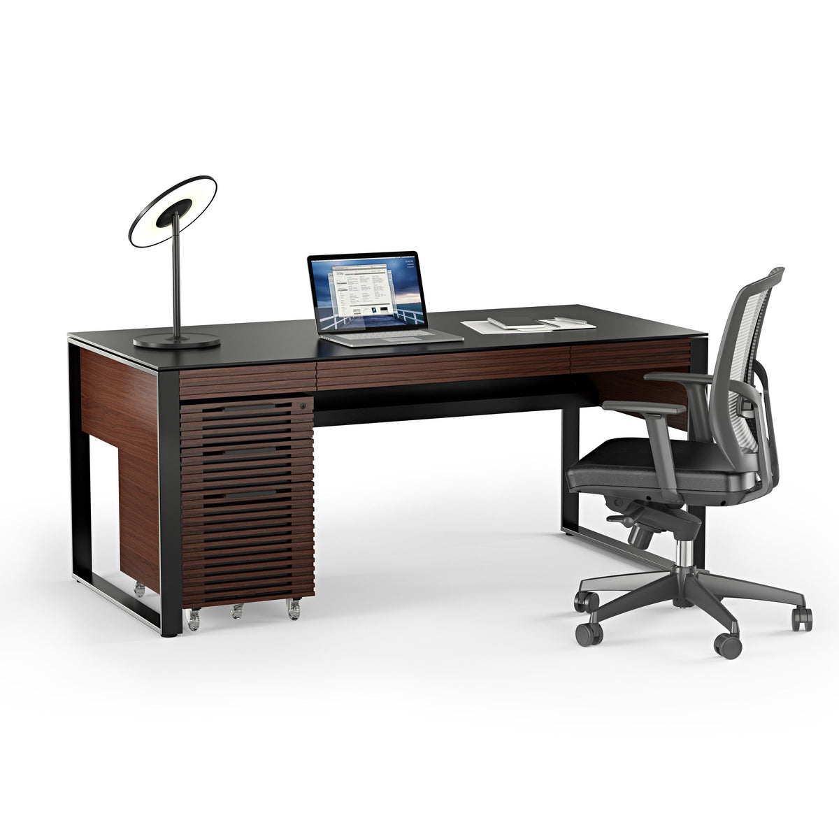 BDi Corridor 6521 Executive Office Desk in Chocolate Stained Walnut, angled view with a file pedestal and chair, on white