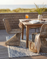 Dash & Albert Tideline Handwoven Indoor/Outdoor Rug in Navy, deck dining setting