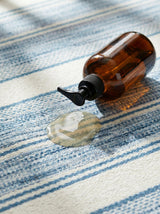 Dash & Albert Ellington Stripe Machine Washable Rug in Blue, close-up with a spill