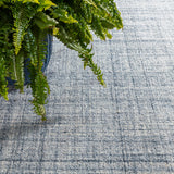 Dash & Albert Harris Hand Micro Hooked Wool Rug in Blue / Ivory, close-up with a fern