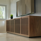 BDi Elements 8703 Media + Storage Cabinet in Natural Walnut, low view in a living room under a wall-mounted TV, with Tune door fronts