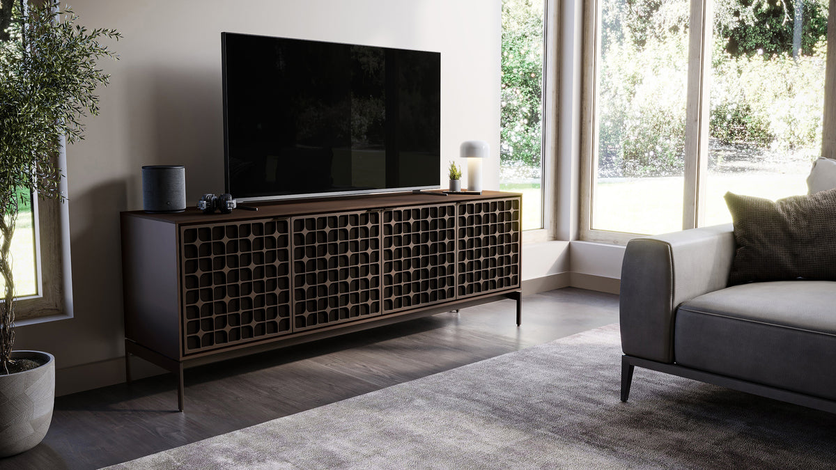 BDi Elements 8709 Media + Storage Console in Toasted Oak, with a TV in a living room by tall windows, with Constellation door fronts