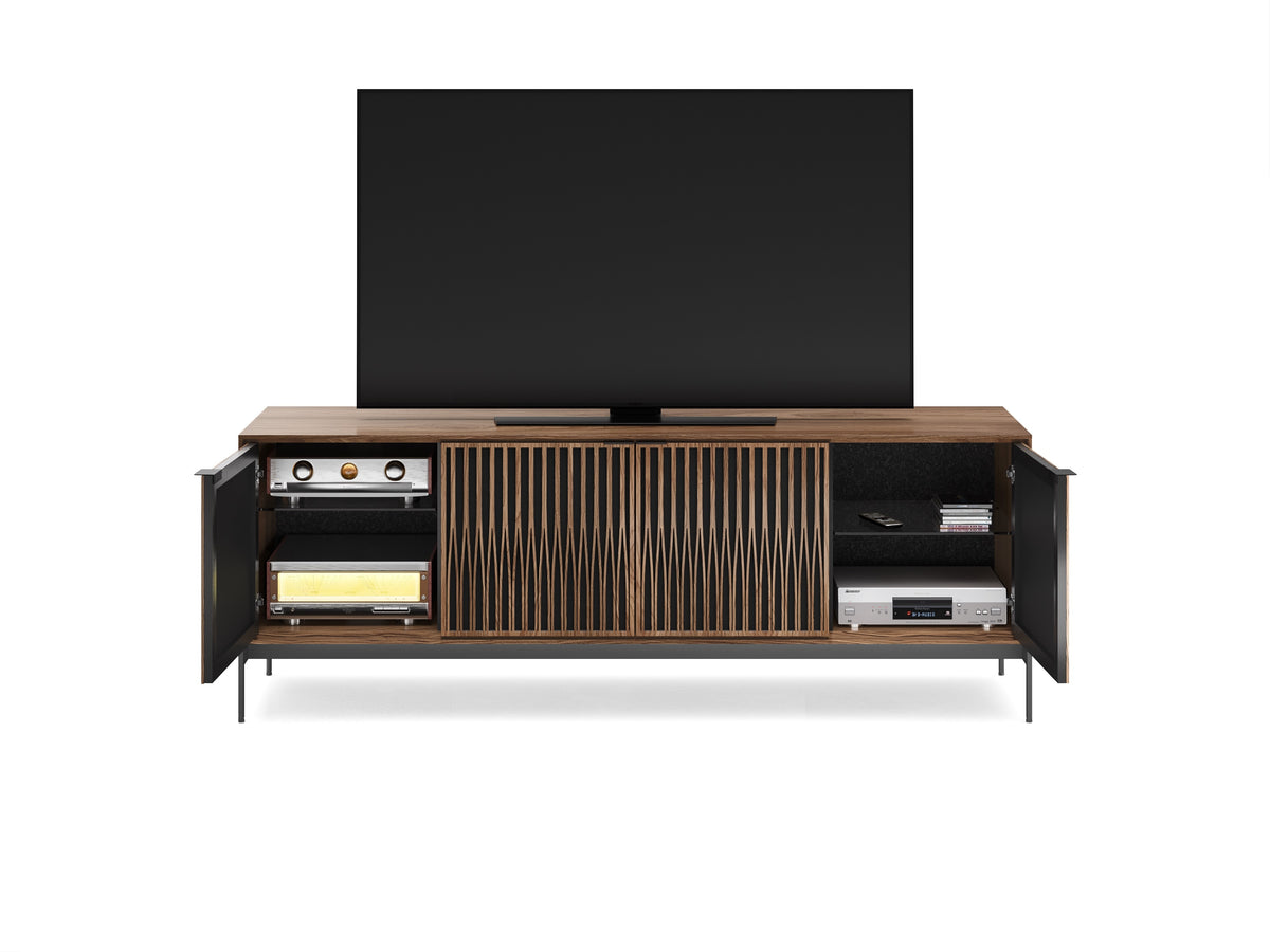 BDi Elements 8709 Media + Storage Console in Natural Walnut, outer doors open with a TV and media equipment, on white, with Tune door fronts