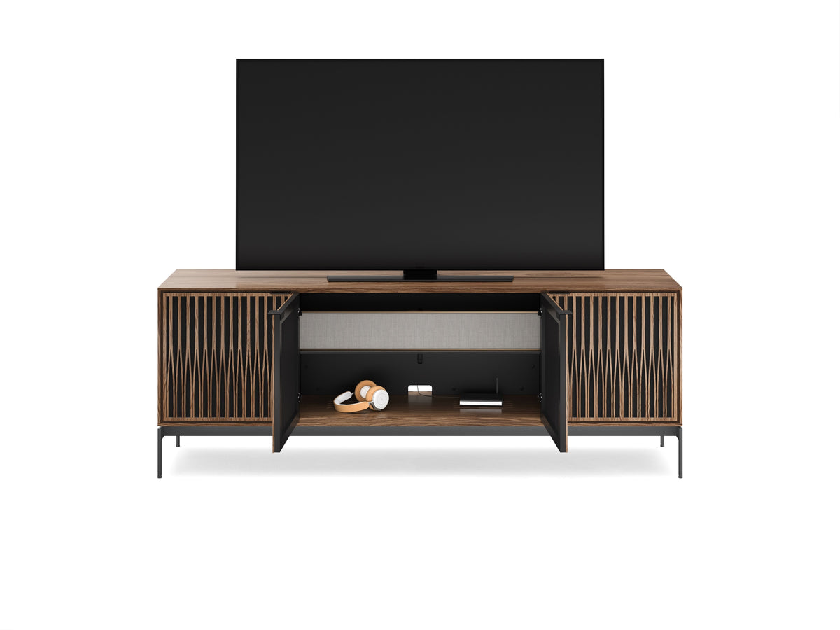 BDi Elements 8709 Media + Storage Console in Natural Walnut, middle doors open with a TV, on white, with Tune door fronts