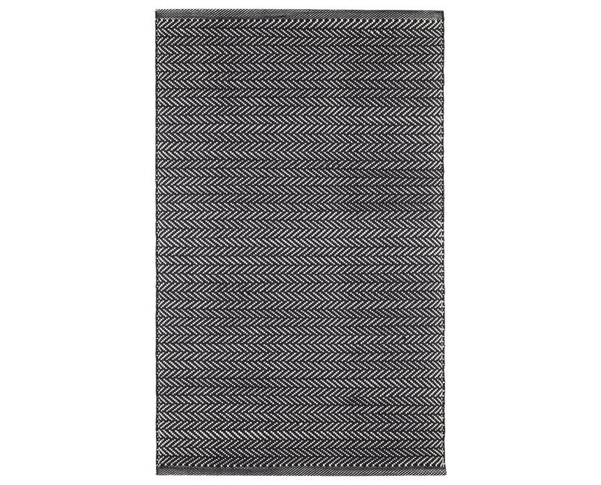 Rug with a herringbone handwoven pattern on a plain background