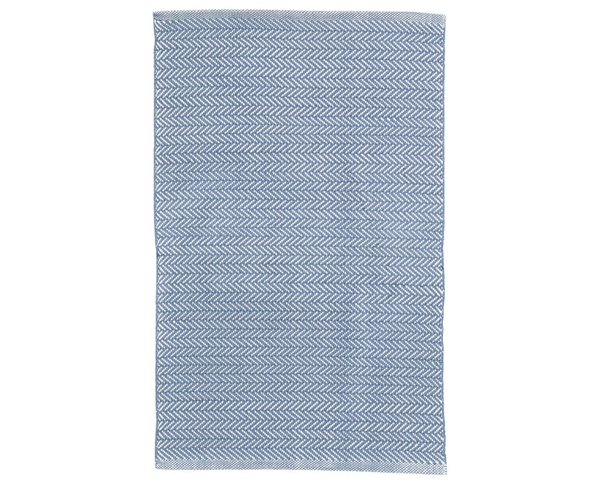 Rug with a herringbone handwoven pattern on a plain background
