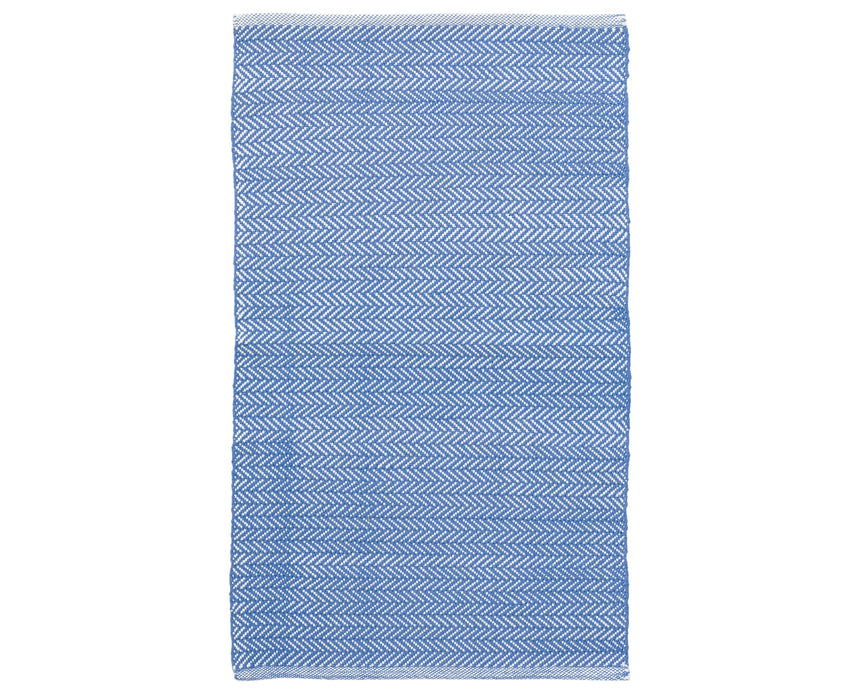 Rug with a herringbone handwoven pattern on a plain background