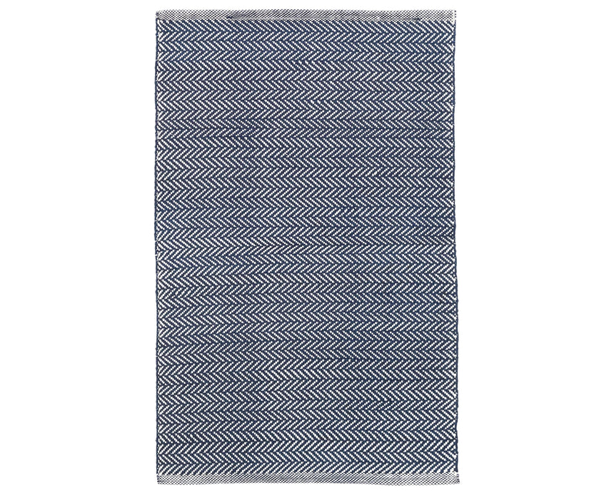 Rug with a herringbone handwoven pattern on a plain background