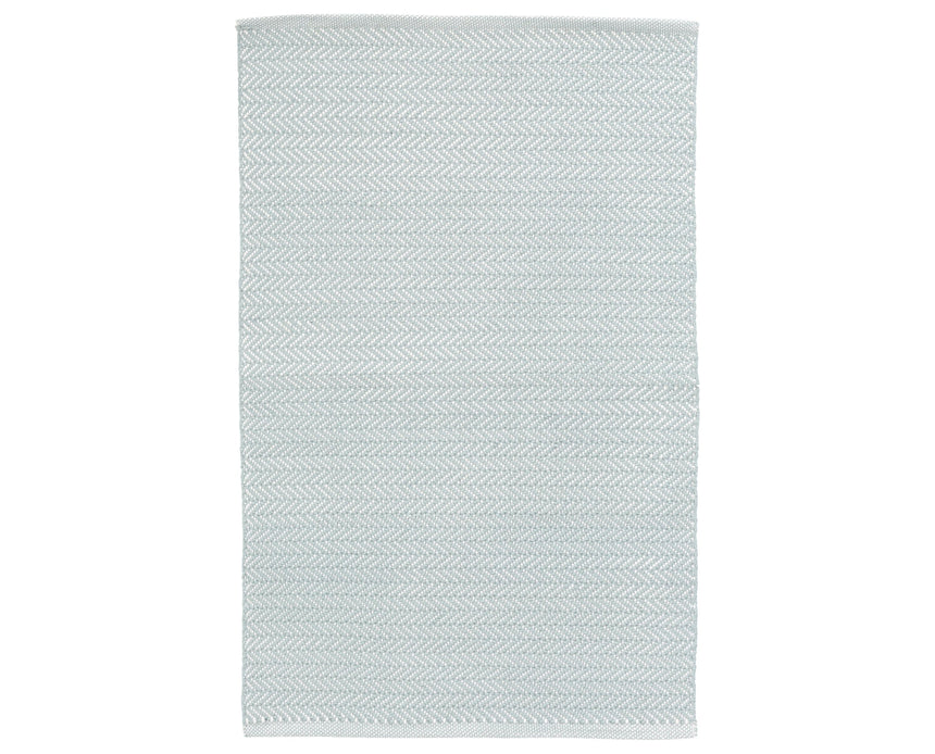 Rug with a herringbone handwoven pattern on a plain background