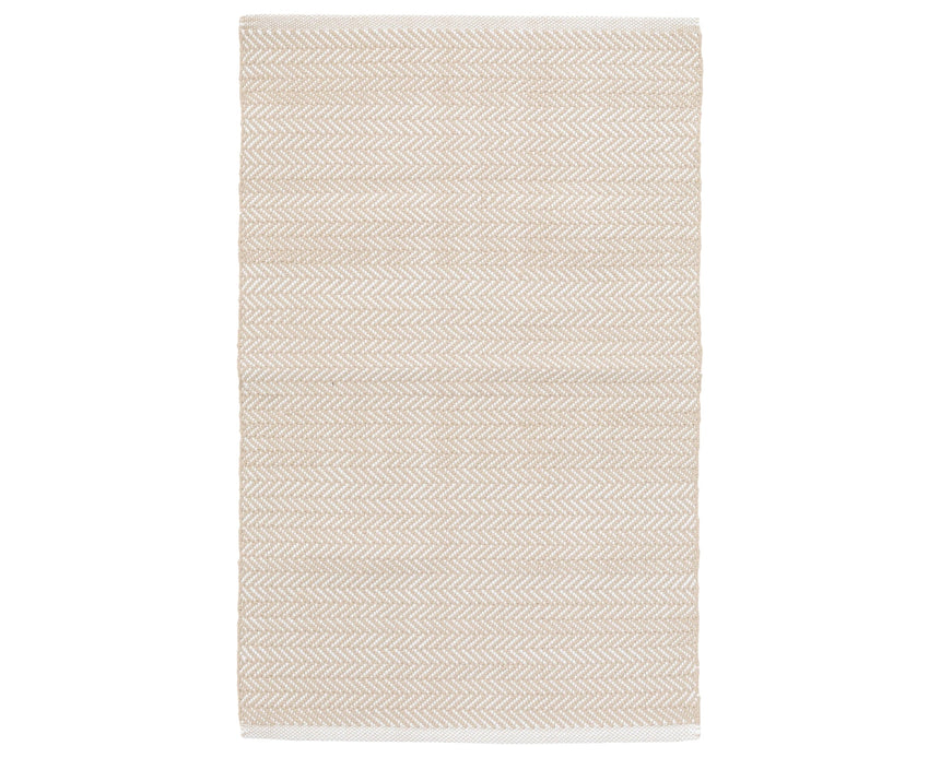 Rug with a herringbone handwoven pattern on a plain background