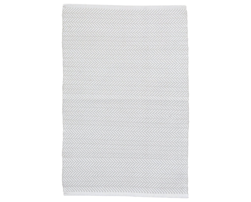 Rug with a herringbone handwoven pattern on a plain background