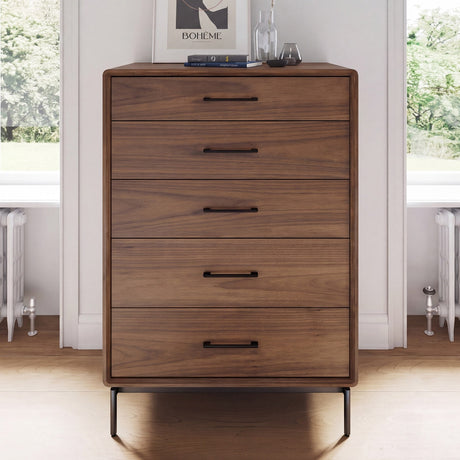 BDi Linq 9185 5 Drawer Chest in Natural Walnut, between two windows in a bright room