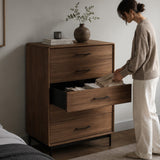 BDi Linq 9185 5 Drawer Chest in Natural Walnut, a woman opening a drawer, in a bedroom