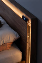 BDi Linq Up-Linq Bed in Natural Walnut, queen, headboard light and charging ledge at night, close-up