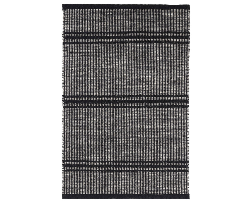 Rug with a Malta Handwoven pattern on a plain background