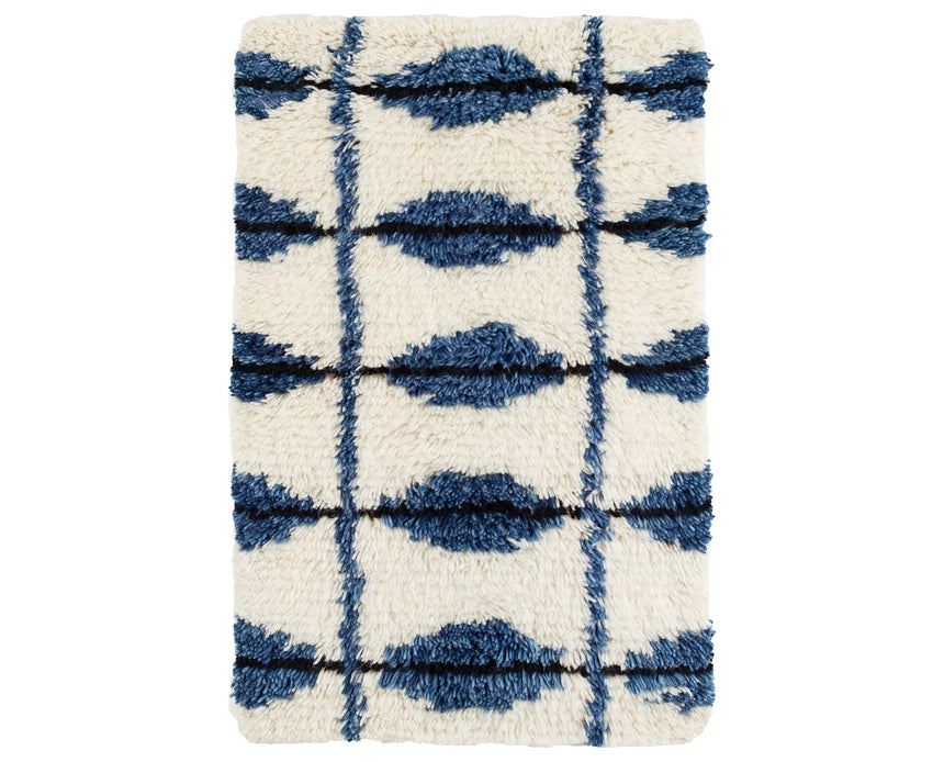 Rug with a Noma Handwoven pattern on a plain background