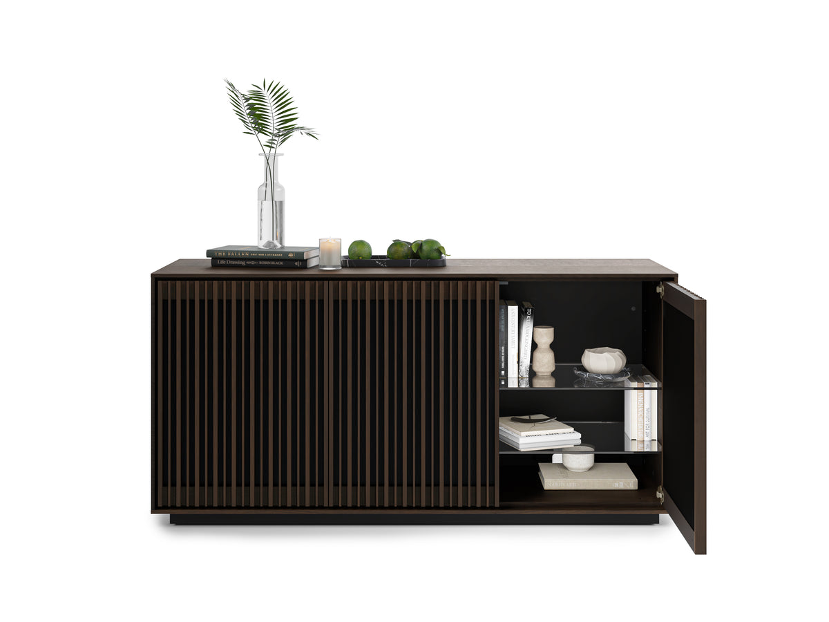 BDi Profile 8477 3-Door Media & Storage Console in Toasted Oak, right door open with books and decor, on white