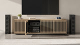 BDi Profile 8479 4-Door Media & Storage Console in Washed Oak, one door open, in a home theatre with tower speakers