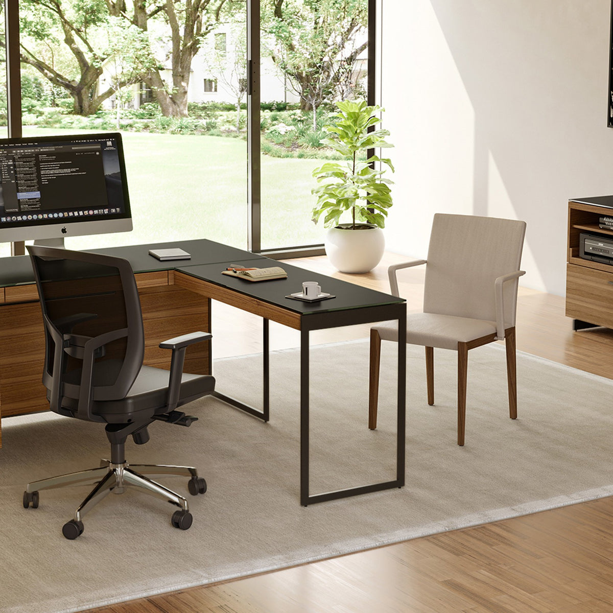 BDi Sequel 20 6112 Desk Extension in Natural Walnut, with a black frame, joined to the desk, in a home office