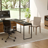 BDi Sequel 20 6112 Desk Extension in Natural Walnut, with a black frame, joined to the desk, in a home office