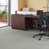 BDi Sequel 20 6116 Lateral File Cabinet in Chocolate Stained Walnut, with a black base, beside a multi-function cabinet under a desk top, in an office