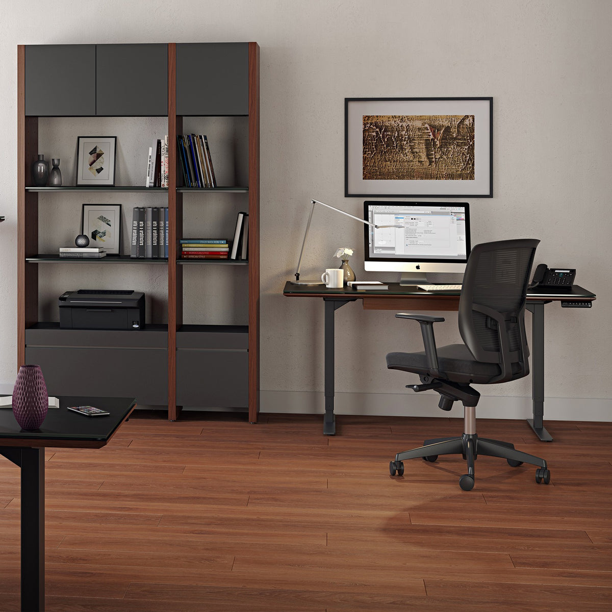 BDi Sequel 20 Sit + Stand Desk in Chocolate Stained Walnut, two desks, one raised, in an office with shelving