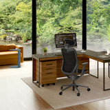 BDi Sequel 20 6107 Mobile File Cabinet in Natural Walnut, under an L-shaped desk, in a home office by a window
