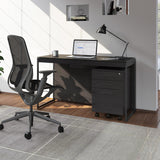 BDi Sequel 20 6103 Compact Laptop Desk in Charcoal Stained Ash, with a black frame, mobile file and multi-function cabinet, in a home office