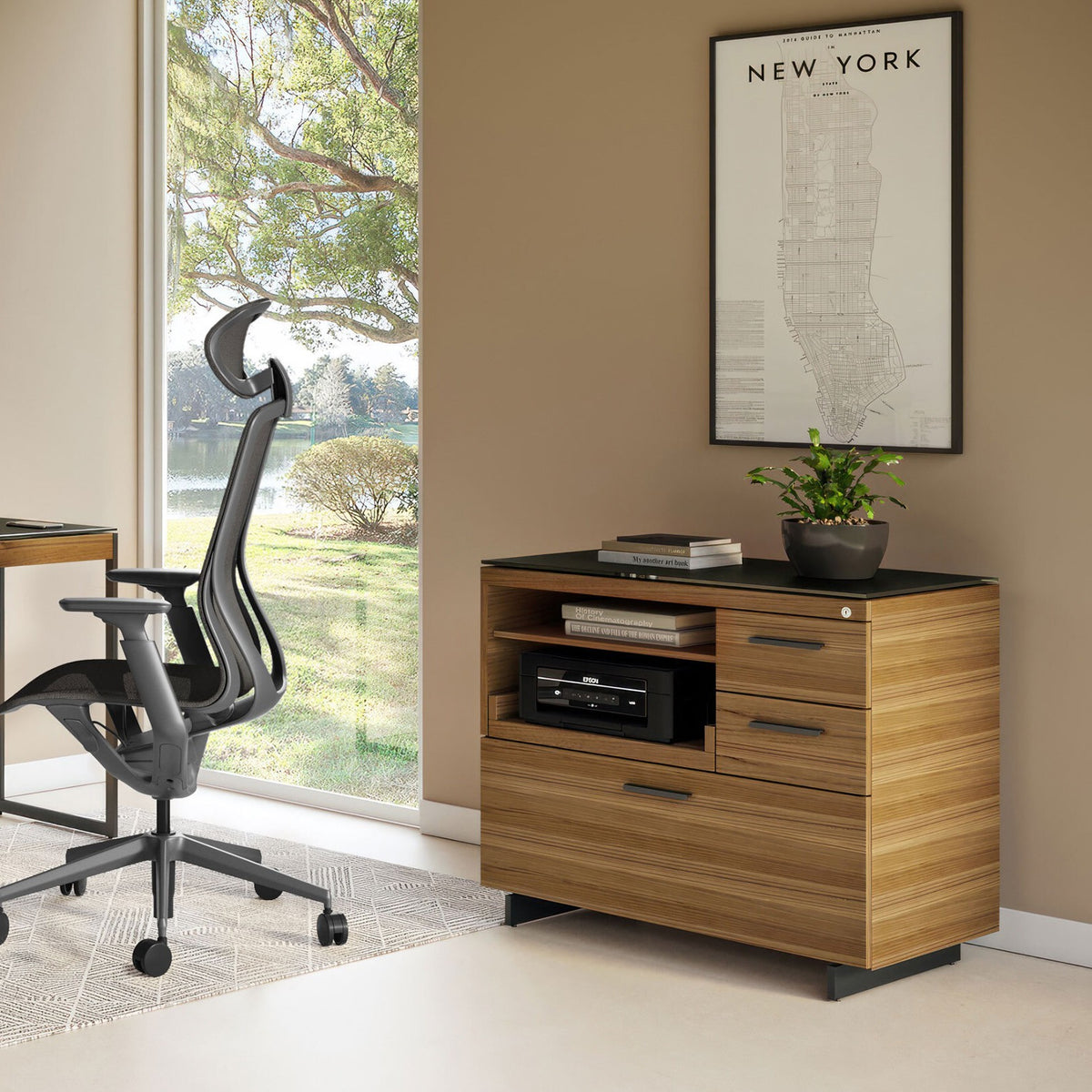 BDi Sequel 20 6117 Multi Function Cabinet in Natural Walnut, with a black base, beside a small desk, in a home office