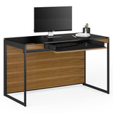 BDi Sequel 20 6103 Compact Laptop Desk in Natural Walnut, with a black frame, keyboard drawer open, with a monitor, on white