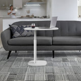 BDi Serif 1045 Adjustable Side/Laptop Table in Salt | Metal, beside a sofa with a laptop