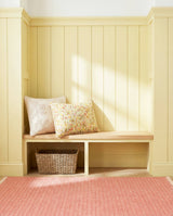 Dash & Albert Herringbone Handwoven Cotton Rug in Coral, window seat setting