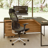 BDi Sequel 20 6101 Desk in Natural Walnut, with a black frame, return and a mesh task chair, in a home office