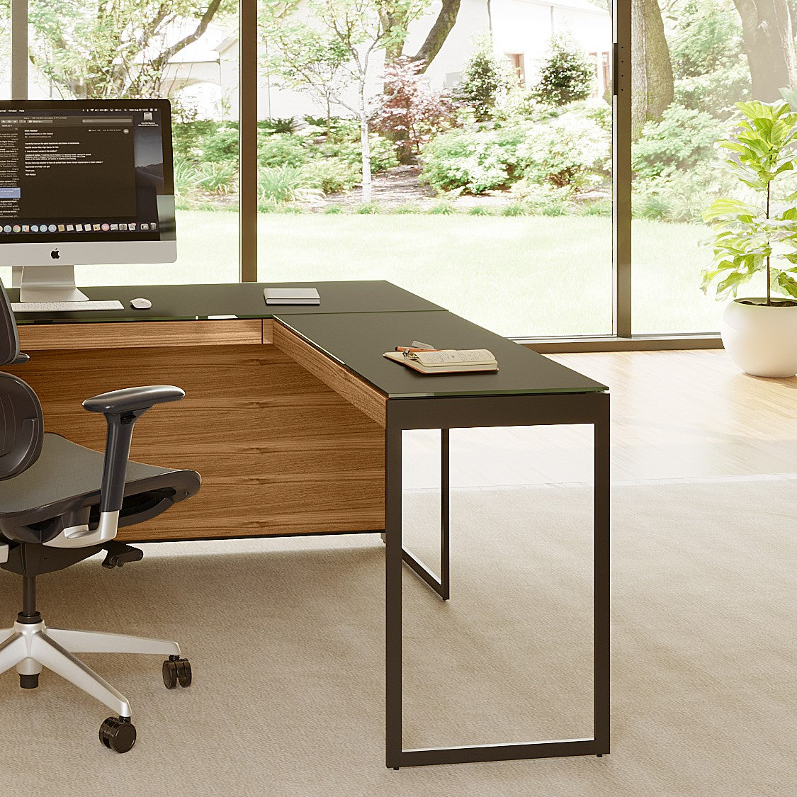 BDi Sequel 20 6112 Desk Extension in Natural Walnut, with a black frame, joined to the desk, in a home office